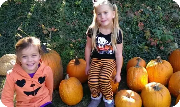 kids on halloween with pumpkins