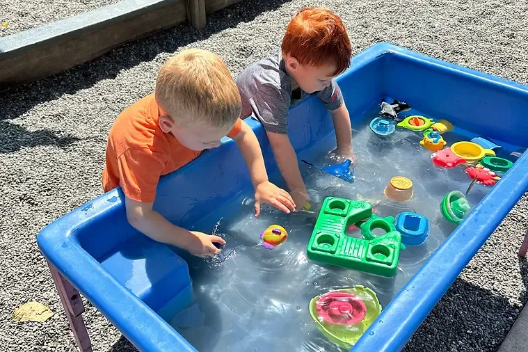 Kids playting at a water table.